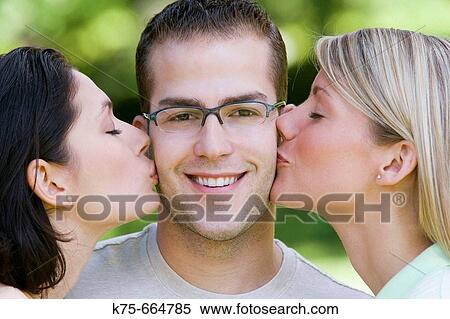 Lucky guy gets kisses from two beautiful women View Large Photo Image Stock Photography - Lucky guy gets kisses from two beautiful women. Fotosearch