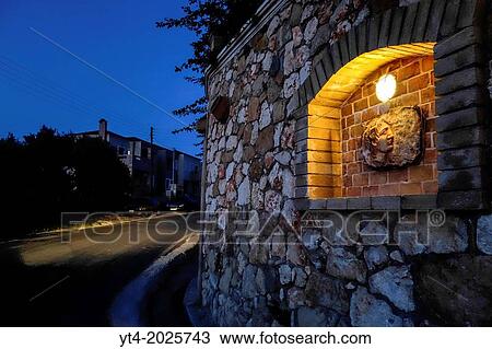 Stock Image - Luxury Villa Wall in Crete Greece showing Stone Carving of Alexander The Great,.. Fotosearch