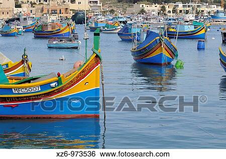 Luzzu, Maltese typical fishing boat on Marsaxlokk harbour, Malta, Europe, november 2009 View Large Photo Image Stock Photograph - Luzzu, Maltese typical fishing boat on Marsaxlokk harbour, Malta, Europe, november 2009. Fotosearch