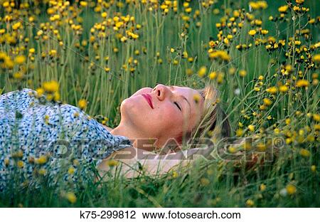 Stock Image - Lying down in wildflowers. Fotosearch