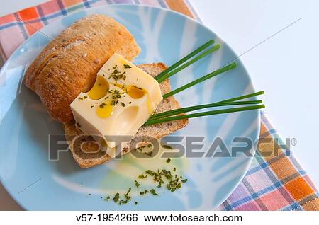 Maasdam cheese on bread with chives and olive oil. Close view. View Large Photo Image Stock Photograph - Maasdam cheese on bread with chives and olive oil. Close view.. Fotosearch