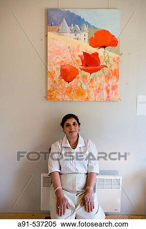 Stock Photography - Madame Fatima, wife of Mr Ahmed the head gardener. La Chatonni? re castle and gardens near Azay-le-Rideau. Indre-et-Loire, France. Fotosearch