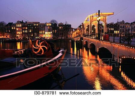 Magere Brug bridge over river Amstel, Amsterdam, The Netherlands View Large Photo Image Stock Image - Magere Brug bridge over river Amstel, Amsterdam, The Netherlands. Fotosearch