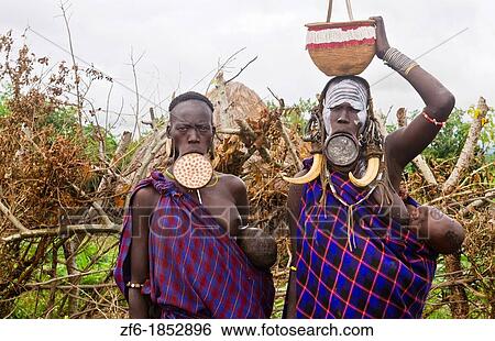 Stock Photograph - Mago National Park Ethiopia Africa Mursi tribe women Lower Omo Valley with clay pots in lips tradition tribal wild pottery 15. Fotosearch