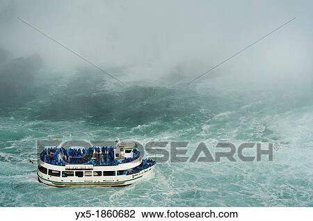 Maid of the Mist boat carrying tourists at the bottom of Niagara Falls View Large Photo Image Stock Image - Maid of the Mist boat carrying tourists at the bottom of Niagara Falls. Fotosearch