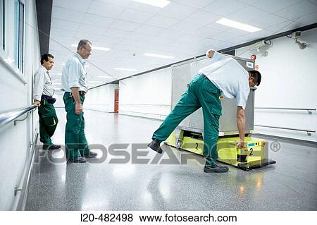 Maintenance employees, robot and trolley for intern transport. Hospital Universitario Gran Canaria Doctor Negrin, Las Palmas de Gran Canaria. Canary Islands, Spain View Large Photo Image Stock Photo - Maintenance employees, robot and trolley for intern transport. Hospital Universitario Gran Canaria Doctor Negrin, Las Palmas de Gran Canaria. Canary Islands, Spain. Fotosearch