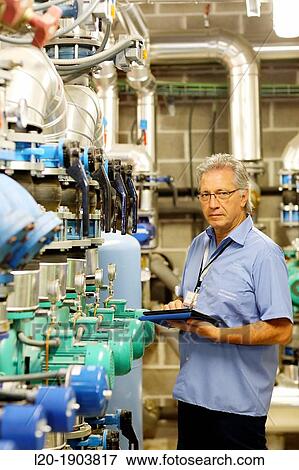 Stock Photo - Maintenance Technician, Pumps ventilation and air conditioning, Onkologikoa Hospital, Oncology Institute, Case Center for prevention, diagnosis and treatment of cancer, Donostia, San Sebastian, Gipuzkoa, Basque Country, Spain. Fotosearch