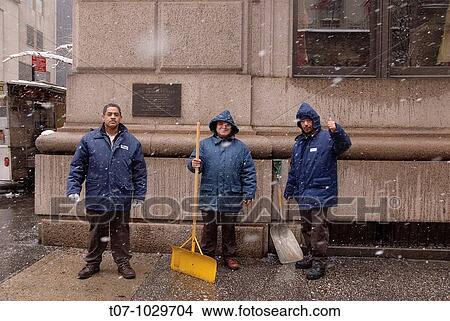 Picture - Maintenance workers pose for a photograph outside The University Club of New York, an Architectural Landmark, 5Th Avenue.. Fotosearch