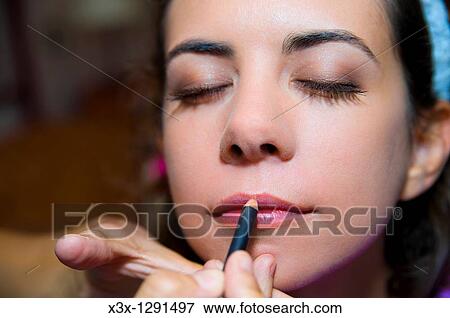 Make up artist applying lips liner on a woman's lips View Large Photo Image Stock Photo - Make up artist applying lips liner on a woman's lips. Fotosearch