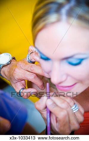 Make up artist applying lips liner View Large Photo Image Stock Image - Make up artist applying lips liner. Fotosearch
