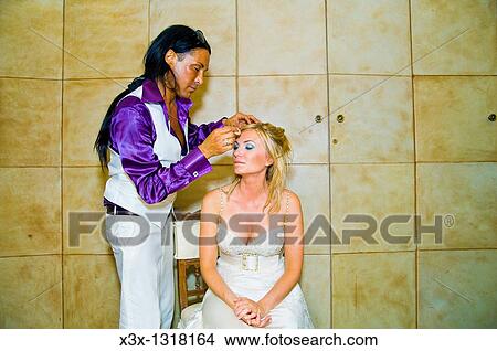 Picture - Make up artist cleansing woman face for a make up session. Fotosearch