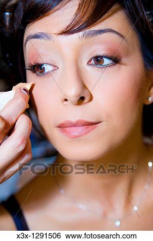 Make up artist clearing out smudge on woman face during a make up session View Large Photo Image Stock Photograph - Make up artist clearing out smudge on woman face during a make up session. Fotosearch