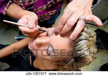Make up artist fixing a model View Large Photo Image Stock Image - Make up artist fixing a model. Fotosearch