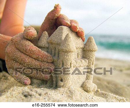 Picture - making a sand castle. Fotosearch