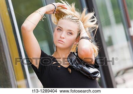 Making pony-tail hair on the street young woman View Large Photo Image Picture - Making pony-tail hair on the street young woman. Fotosearch
