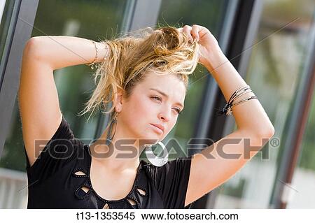 Making pony-tail hair on the street young woman View Large Photo Image Stock Photography - Making pony-tail hair on the street young woman. Fotosearch