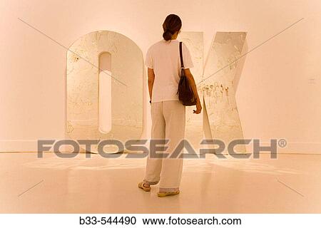 Stock Image - Malaga Costa del Sol Spain Centro de Arte Contemporaneo de Malaga. Visitor viewing Everything is OK by Jonathan Hernandez. Fotosearch