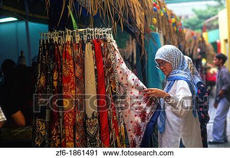Malaysia, Kuala Lumpur, Bumi Putra, Woman touching scarf at market View Large Photo Image Stock Image - Malaysia, Kuala Lumpur, Bumi Putra, Woman touching scarf at market. Fotosearch