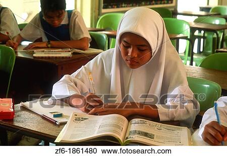 Malaysia, Kuala Lumpur, Muslim school children writing in classroom View Large Photo Image Stock Image - Malaysia, Kuala Lumpur, Muslim school children writing in classroom. Fotosearch