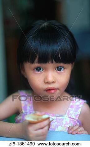 Malaysia, Kuala Lumpur, Portrait of young girl View Large Photo Image Stock Image - Malaysia, Kuala Lumpur, Portrait of young girl. Fotosearch