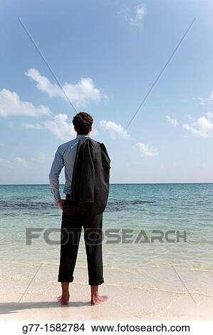 Picture - Maldives Islands Ari Atoll Business man on a beach.. Fotosearch