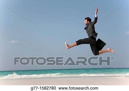 Maldives Islands Ari Atoll Business man jumping on the beach. View Large Photo Image Stock Image - Maldives Islands Ari Atoll Business man jumping on the beach.. Fotosearch