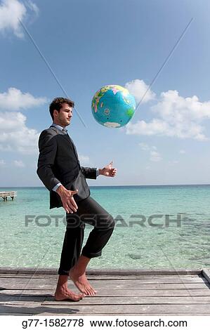 Maldives Islands Ari Atoll Business man playing with world globe. View Large Photo Image Stock Photo - Maldives Islands Ari Atoll Business man playing with world globe.. Fotosearch