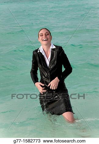 Stock Image - Maldives Islands Ari Atoll Business woman in sea.. Fotosearch