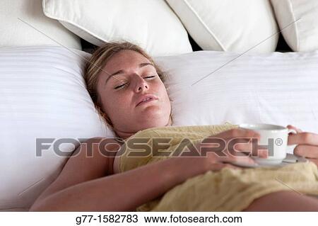 Maldives Islands Ari Atoll Woman in bed with a cup of coffee. View Large Photo Image Stock Image - Maldives Islands Ari Atoll Woman in bed with a cup of coffee.. Fotosearch