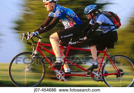 Male and female bicyclists. View Large Photo Image Stock Photograph - Male and female bicyclists.. Fotosearch