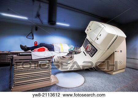 Male cancer patient lying under a linear accelerator or linac receiving radiation treatment. View Large Photo Image Stock Image - Male cancer patient lying under a linear accelerator or linac receiving radiation treatment.. Fotosearch