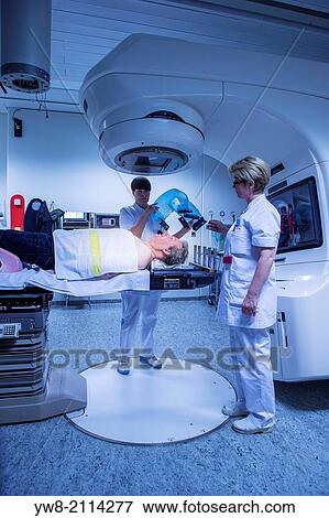 Male cancer patient lying under a linear accelerator or linac receiving radiation treatment. View Large Photo Image Stock Photo - Male cancer patient lying under a linear accelerator or linac receiving radiation treatment.. Fotosearch