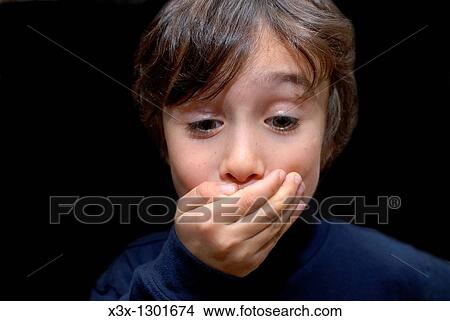 Male child keeping a secret with a hand over his mouth View Large Photo Image Picture - Male child keeping a secret with a hand over his mouth. Fotosearch