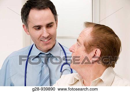 male doctor and senior male patient during a medical examination View Large Photo Image Stock Image - male doctor and senior male patient during a medical examination. Fotosearch