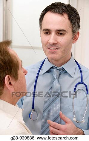 male doctor and senior male patient during a medical examination View Large Photo Image Stock Photograph - male doctor and senior male patient during a medical examination. Fotosearch