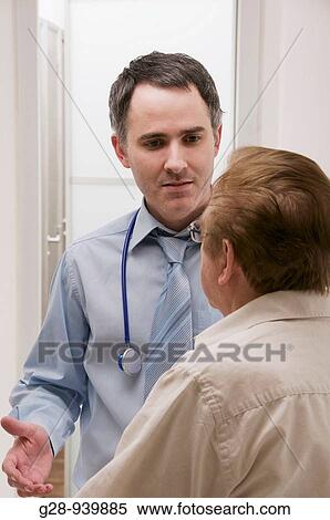 male doctor receiving a senior male patient for a medical examination View Large Photo Image Stock Photography - male doctor receiving a senior male patient for a medical examination. Fotosearch