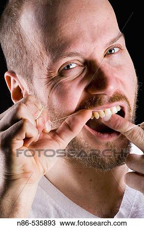 Male flossing teeth View Large Photo Image Stock Image - Male flossing teeth. Fotosearch