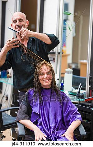 Male hairdresser cutting hair to woman at beauty salon View Large Photo Image Stock Image - Male hairdresser cutting hair to woman at beauty salon. Fotosearch