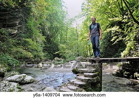 Male hiker at Kozjak brook, Kobarid, Slovenia, Triglav National Park, Julian Alps, Slovenia View Large Photo Image Picture - Male hiker at Kozjak brook, Kobarid, Slovenia, Triglav National Park, Julian Alps, Slovenia. Fotosearch