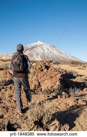 Male hiker in Teide national park with snow covered El Teide in background Tenerife, Canary Islands, Spain View Large Photo Image Stock Photography - Male hiker in Teide national park with snow covered El Teide in background Tenerife, Canary Islands, Spain. Fotosearch