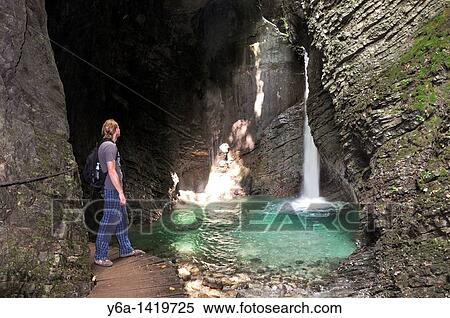 Male hiker lokking at Kozjak Waterfall, Kobarid, Julian Alps, Slovenia, Europe View Large Photo Image Stock Photography - Male hiker lokking at Kozjak Waterfall, Kobarid, Julian Alps, Slovenia, Europe. Fotosearch