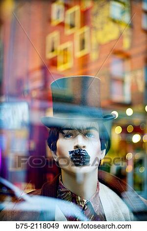 Male mannequin with a top hat and his mouth covered with an adhesive paper, seen through glass with a city reflections. London, England, UK, Europe. View Large Photo Image Stock Photo - Male mannequin with a top hat and his mouth covered with an adhesive paper, seen through glass with a city reflections. London, England, UK, Europe.. Fotosearch
