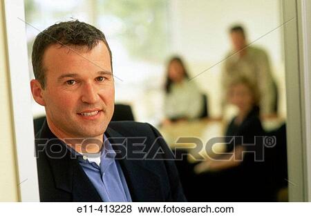 Male office worker in doorway of conference room View Large Photo Image Stock Photo - Male office worker in doorway of conference room. Fotosearch