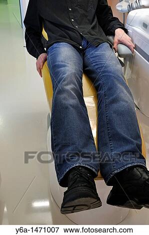 Male patient sitting in dentist's chair View Large Photo Image Stock Photo - Male patient sitting in dentist's chair. Fotosearch