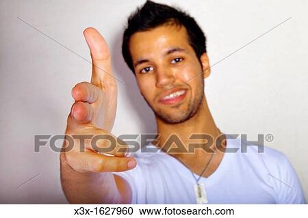 Male portrait holding hand like a gun View Large Photo Image Stock Image - Male portrait holding hand like a gun. Fotosearch
