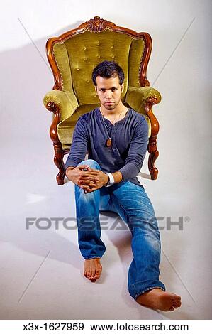 Stock Photo - Male portrait sitting on the floor. Fotosearch