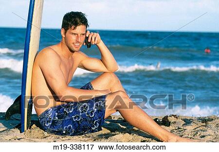 male surfer talking on cel phone View Large Photo Image Stock Photo - male surfer talking on cel phone. Fotosearch
