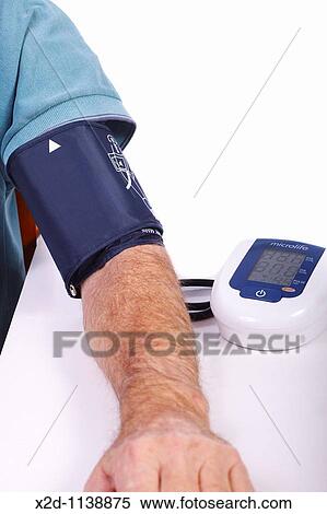 Stock Photography - Male with blood pressure meter attached to his arm. Fotosearch