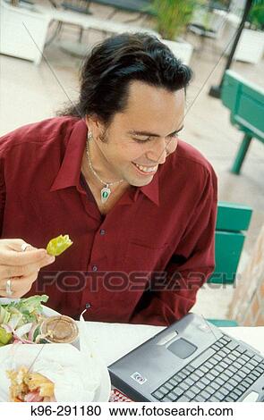 Male with lap tap at cafe View Large Photo Image Stock Image - Male with lap tap at cafe. Fotosearch