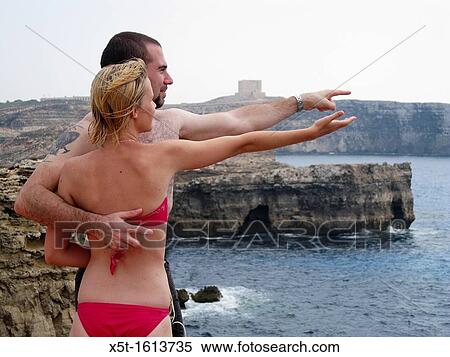 Stock Photography - Malta, holiday makers looking out towards the Mediterranean Sea. Fotosearch